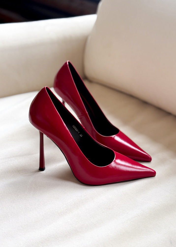 Red high-heeled shoes on a white surface